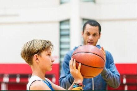 cropped-basketball_01.jpeg a boy holding a basketball