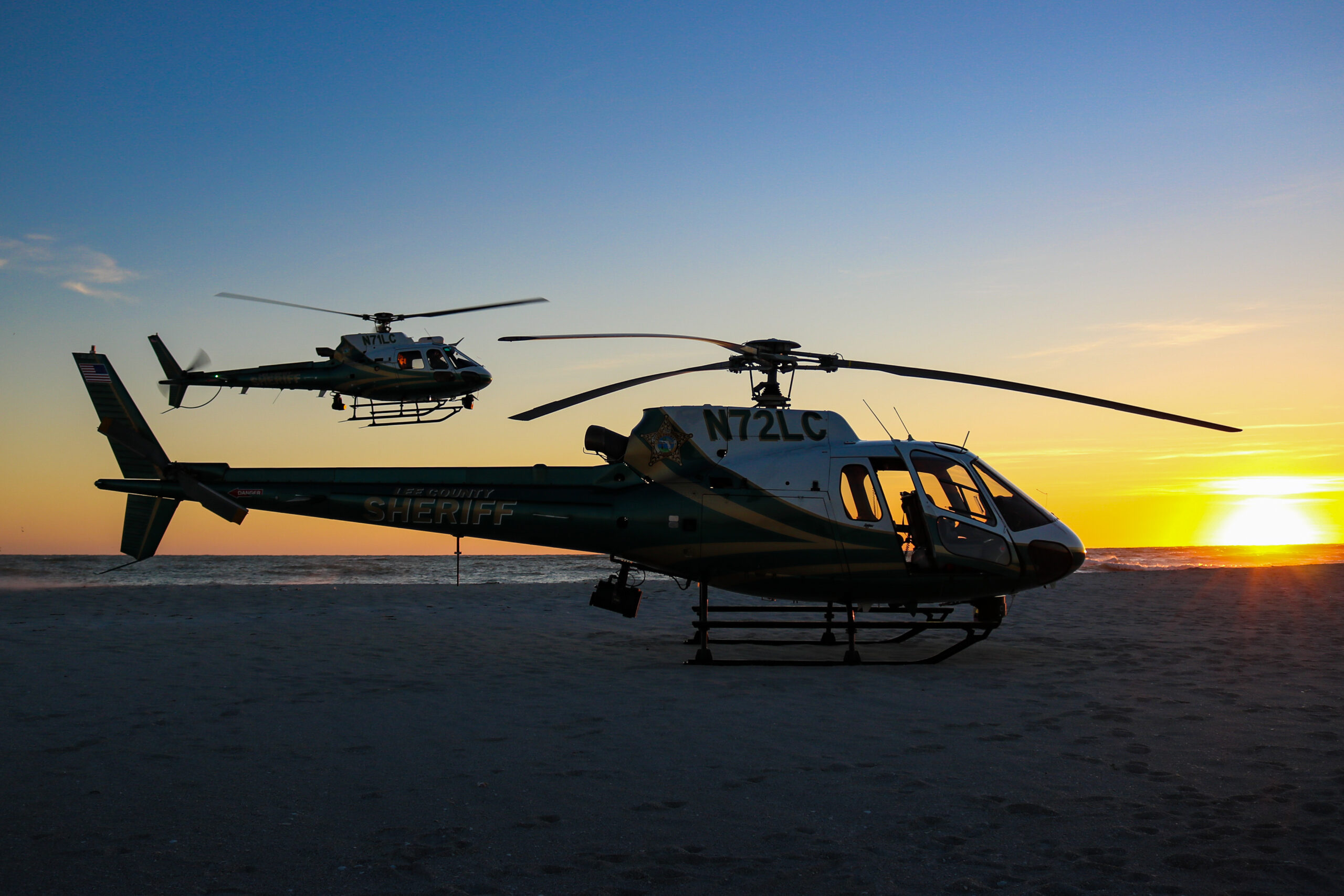 a couple of helicopters on a beach