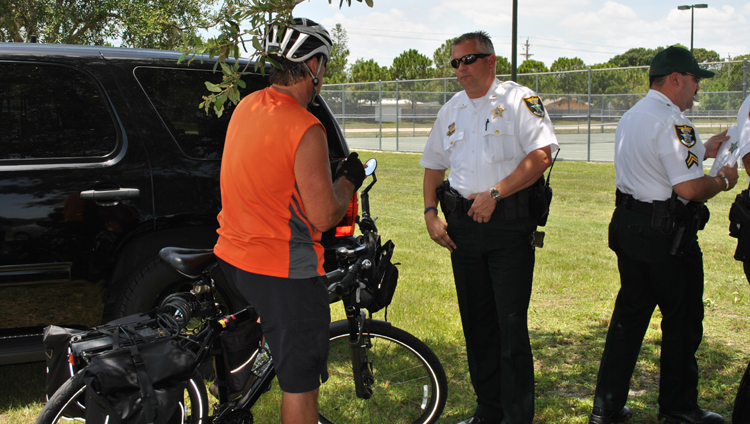 Bike-Safety a group of men standing next to a motorcycle