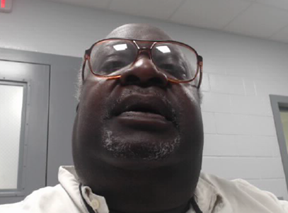cropped-brown-1.png a man with a beard and glasses